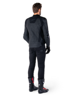 Alpinestars Missile V3 Leather Jacket in Black, rear view on a rider, worn with black pants and black and red racing boots, featuring sleek leather construction with tonal branding and a performance race fit
