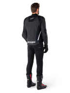Alpinestars Missile V3 Leather Jacket, Black and White, rear view on rider, featuring bold white Alpinestars branding on the lower back and small logo on the upper back, worn with black pants and racing boots, premium leather construction for motorcycle racing