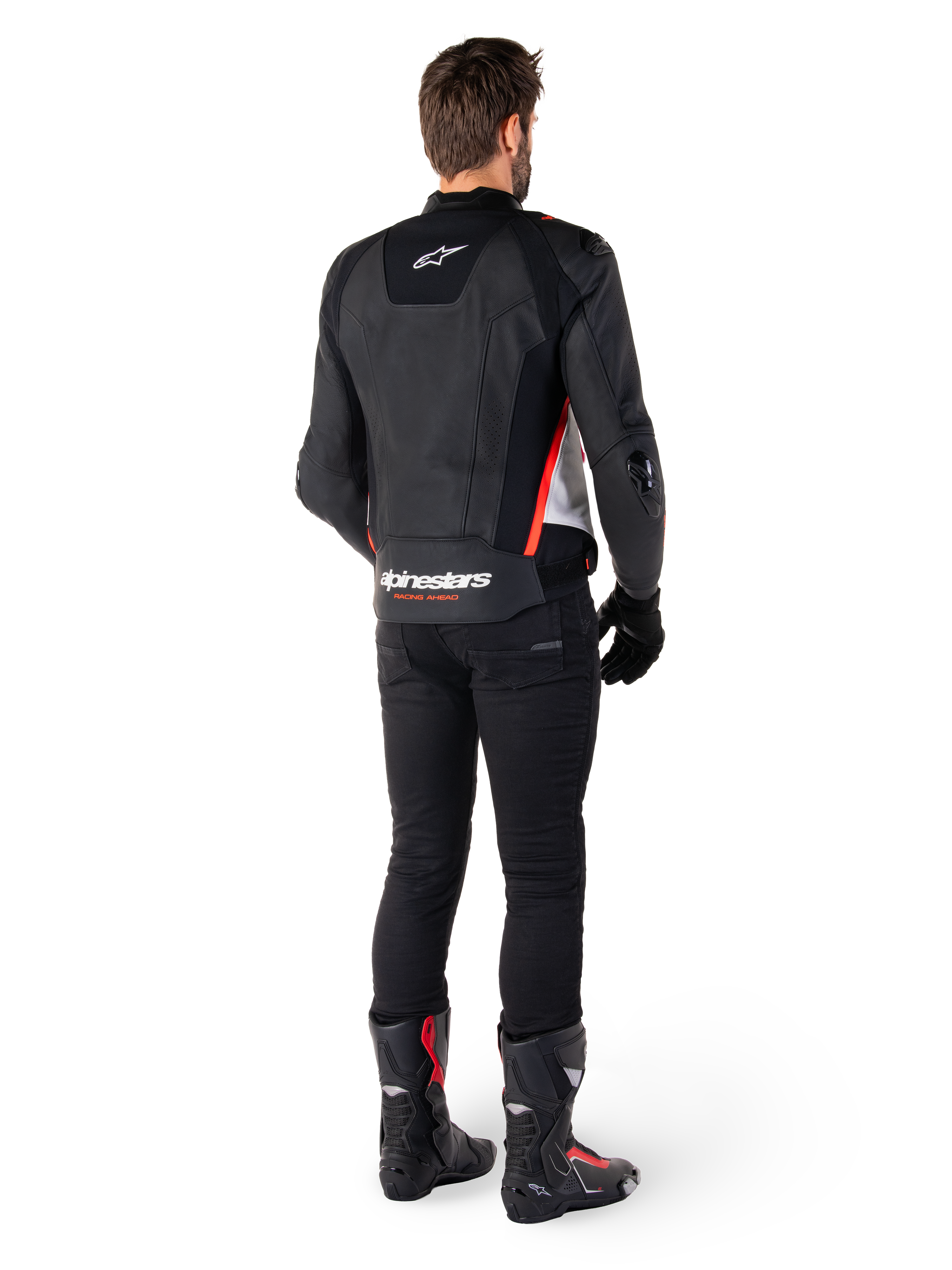 Alpinestars Missile V3 Leather Jacket in Black White Red Fluo, back view on a male rider, featuring Alpinestars branding on the upper and lower back, paired with black pants and motorcycle boots, racing-inspired leather sport jacket.