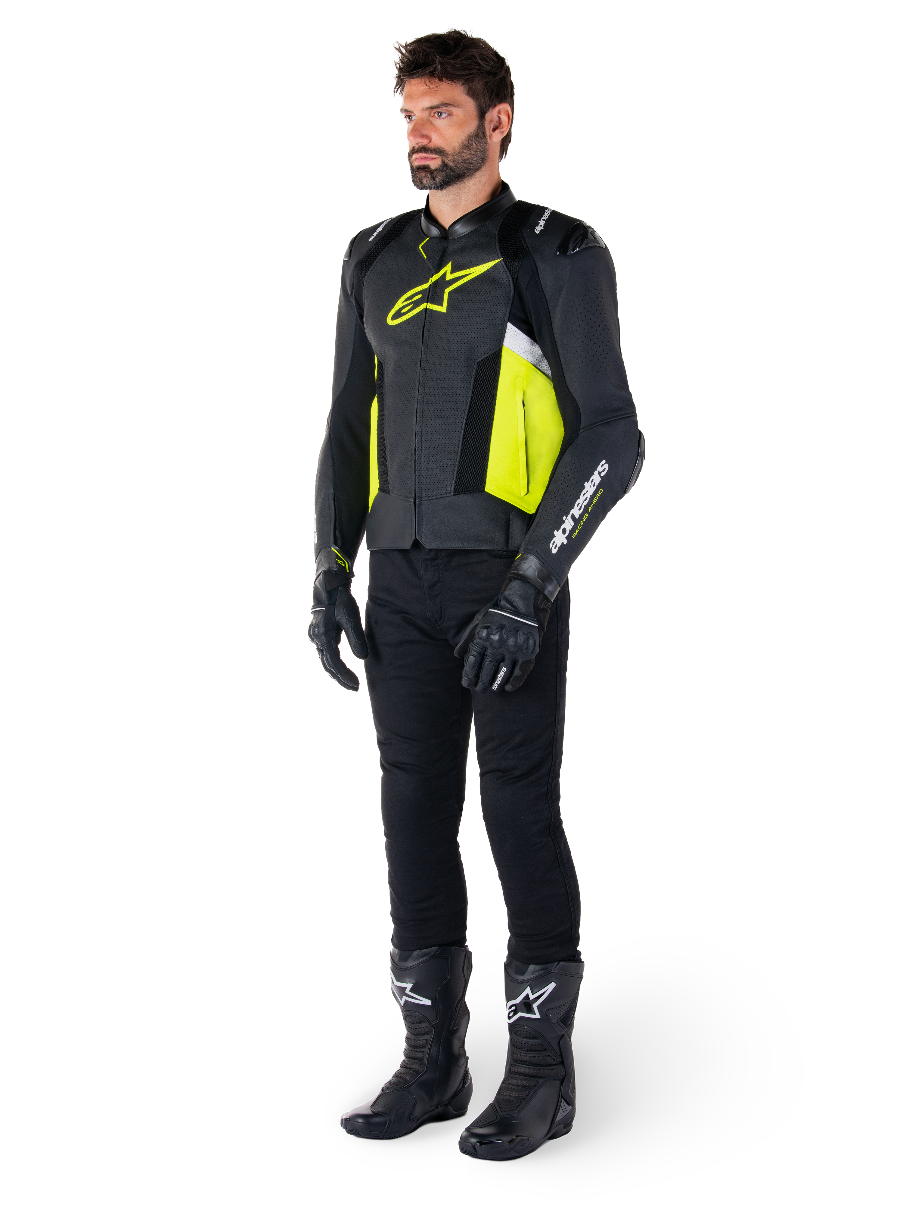 Male model wearing the Alpinestars Missile V3 Airflow Leather Jacket in Black, Yellow Fluo, and White, styled with black riding gloves, pants, and boots, showcasing the perforated leather design and racing-inspired aesthetic.
