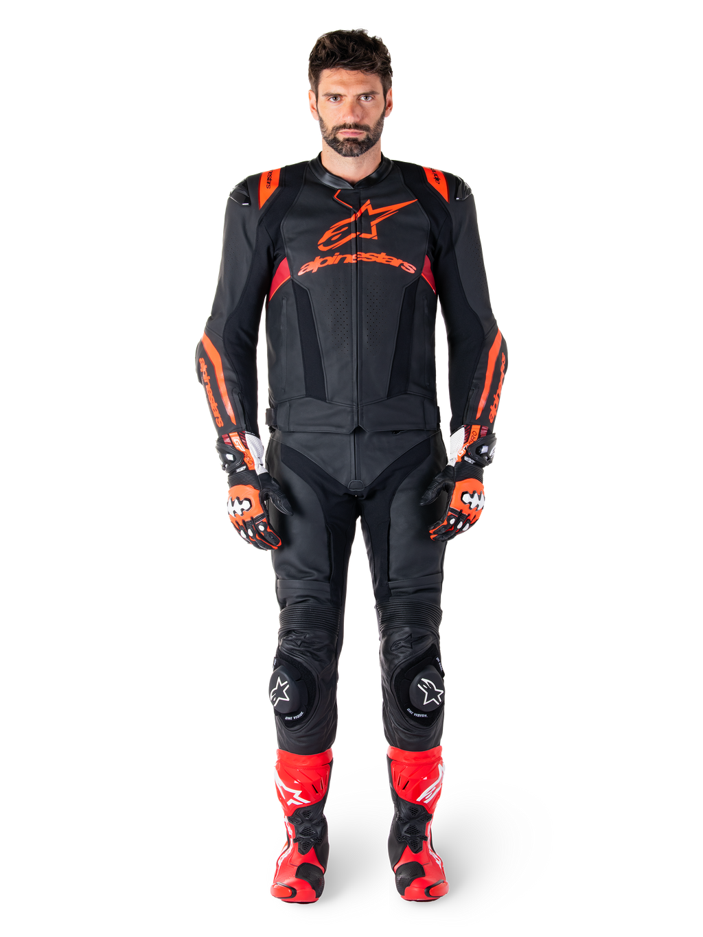 Male model wearing Alpinestars Missile V3 Ignition Leather Jacket in Black Red Fluo Dark Red, complete motorcycle racing gear including matching leather pants, racing gloves, and boots, featuring bold Alpinestars branding on the chest, forward-facing pose, professional sport riding outfit