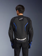 Alpinestars GP Force V2 Airflow Leather Jacket, Black Metallic Blue, back view, featuring a large perforated back panel for ventilation, blue accents, and white Alpinestars branding, worn with matching blue gloves and black pants for sport riding.