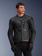 Alpinestars GP Plus R V4 Airflow Leather Jacket, Black, Motorcycle Racing Jacket with perforated leather construction, featuring prominent ASTARS chest branding and DFS shoulder protection, worn with black and red gloves