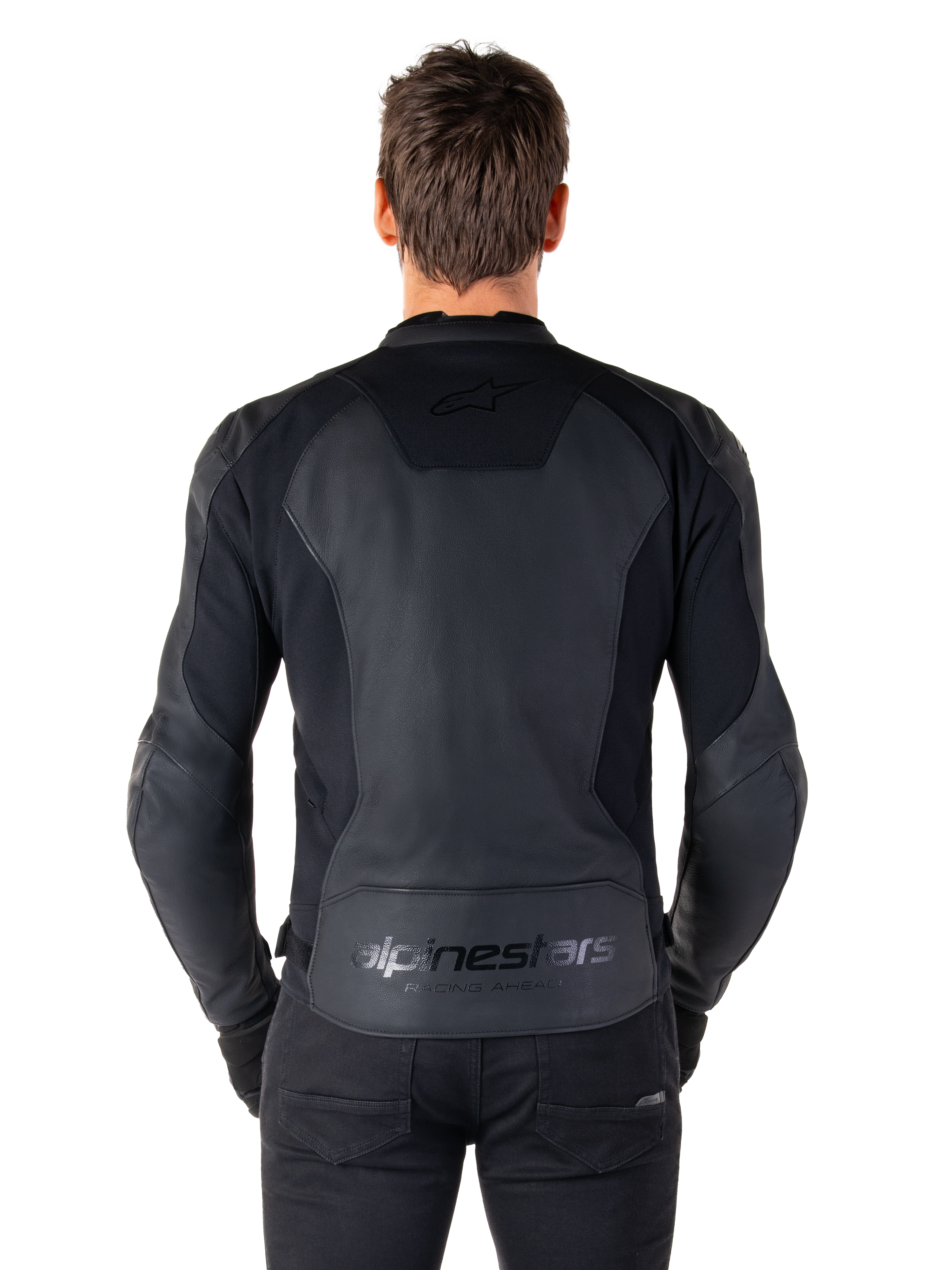 Rear view of a man wearing the Alpinestars Faster V3 Leather Jacket in Black Black, featuring premium leather panels and flexible stretch inserts, subtle 'alpinestars' and 'RACING AHEAD' branding on the lower back, athletic sport fit for motorcycle riding.