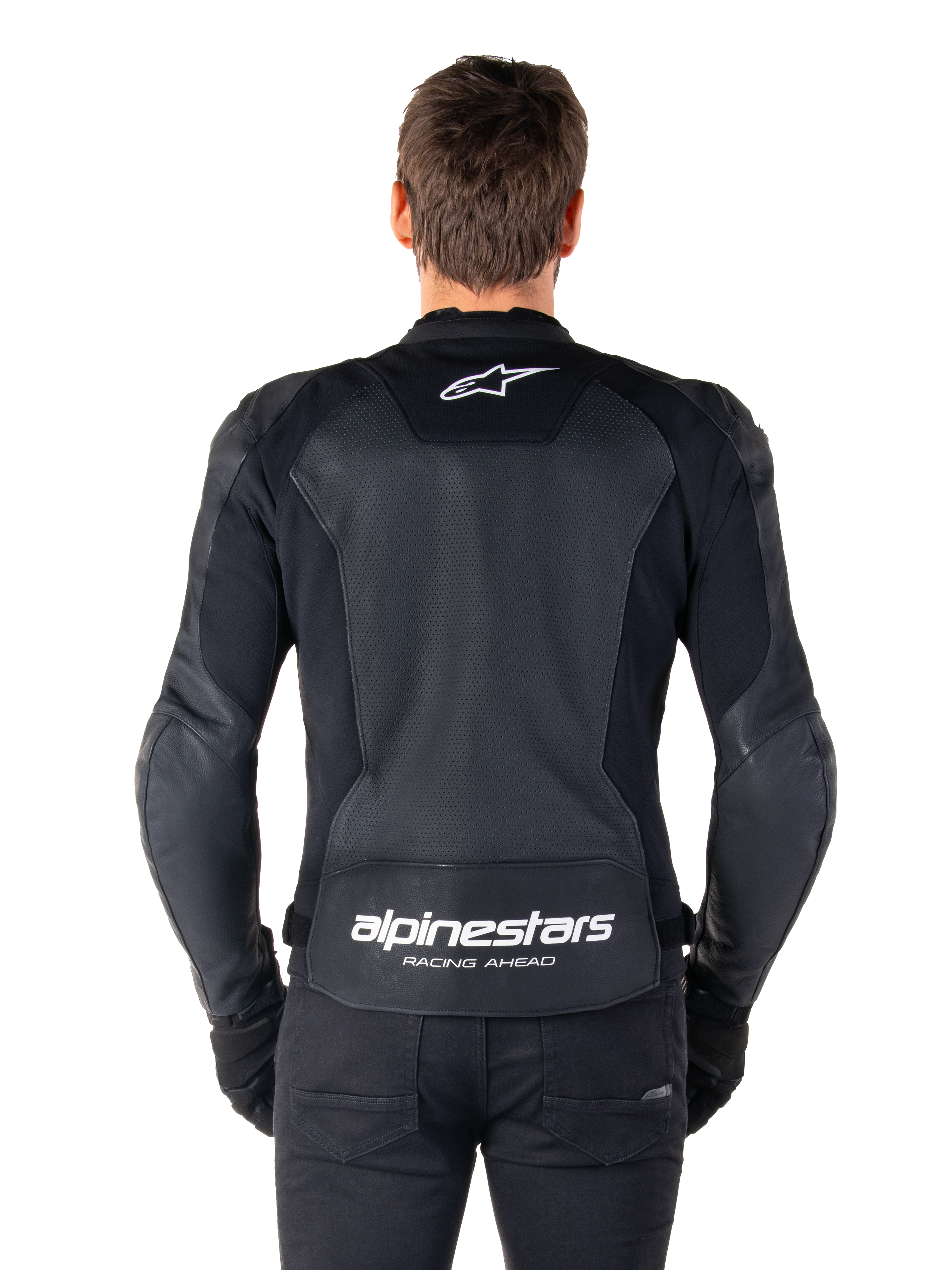 Alpinestars Faster V3 Airflow Leather Jacket, Black and White, rear view of a rider showing the perforated leather back panel for ventilation, white Alpinestars logo on upper back and 'RACING AHEAD' branding on lower back, sport-fit motorcycle gear.
