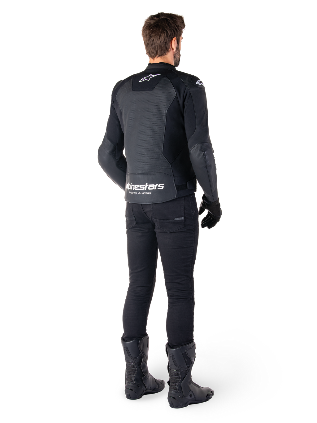 Alpinestars Faster V3 Airflow Leather Jacket, Black and White, rear view showing perforated leather panels and prominent Alpinestars branding on the lower back, worn by a rider with black riding pants, gloves, and boots.