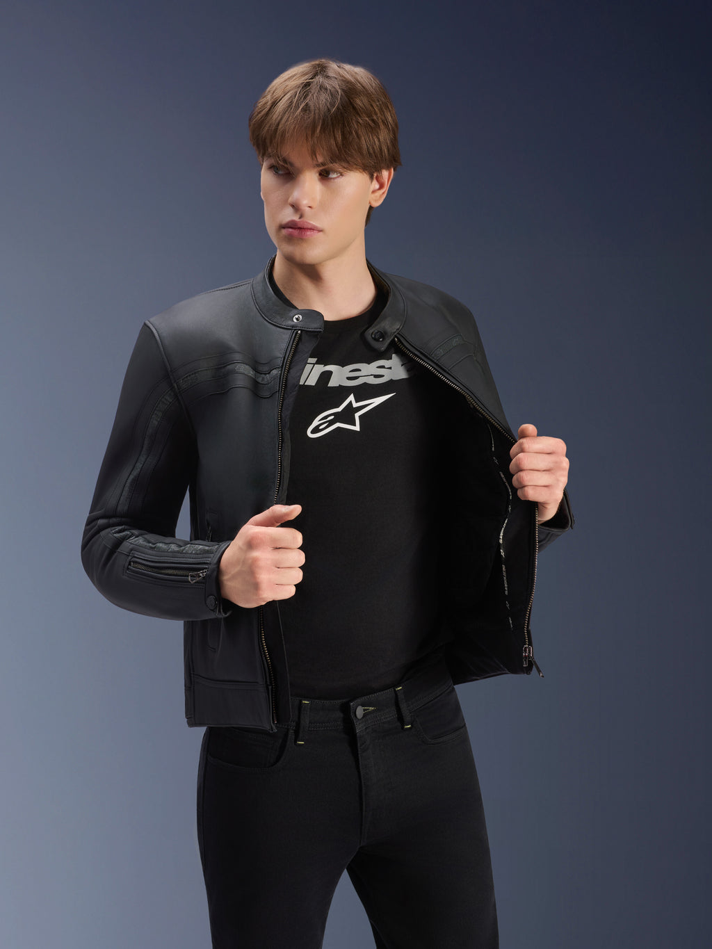 Alpinestars Dyno Leather Jacket, Black, worn by a male model over a black logo t-shirt, premium bovine leather motorcycle jacket with a heritage-inspired design, featuring subtle chest stripes and a contemporary urban fit.