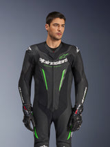 Alpinestars GP Force V2 Leather Suit - 1Piece, Black and Green motorcycle racing suit, worn by model, featuring perforated leather panels, bold white Alpinestars branding on chest and sleeves, and integrated shoulder protection for track performance.