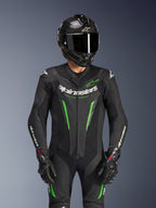 Alpinestars GP Force V2 Leather Suit - 1Piece, Black and Green, motorcycle racing suit worn with a carbon fiber helmet and GP Pro gloves, featuring lime green accents and Alpinestars 'Racing Ahead' branding, engineered for track performance.