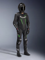 Alpinestars GP Force V2 Leather Suit - 1Piece, Black and Green, worn with matching black helmet, racing gloves, and boots, featuring bright green accents and bold white Alpinestars branding, professional track and sport riding gear