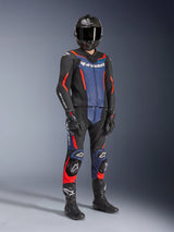 Alpinestars GP Force V2 Leather Suit - 2Piece in Black, Blue, and Red Fluo, worn with a carbon fiber helmet, black racing gloves, and boots, featuring perforated leather panels and white Alpinestars logo, professional sport riding gear.