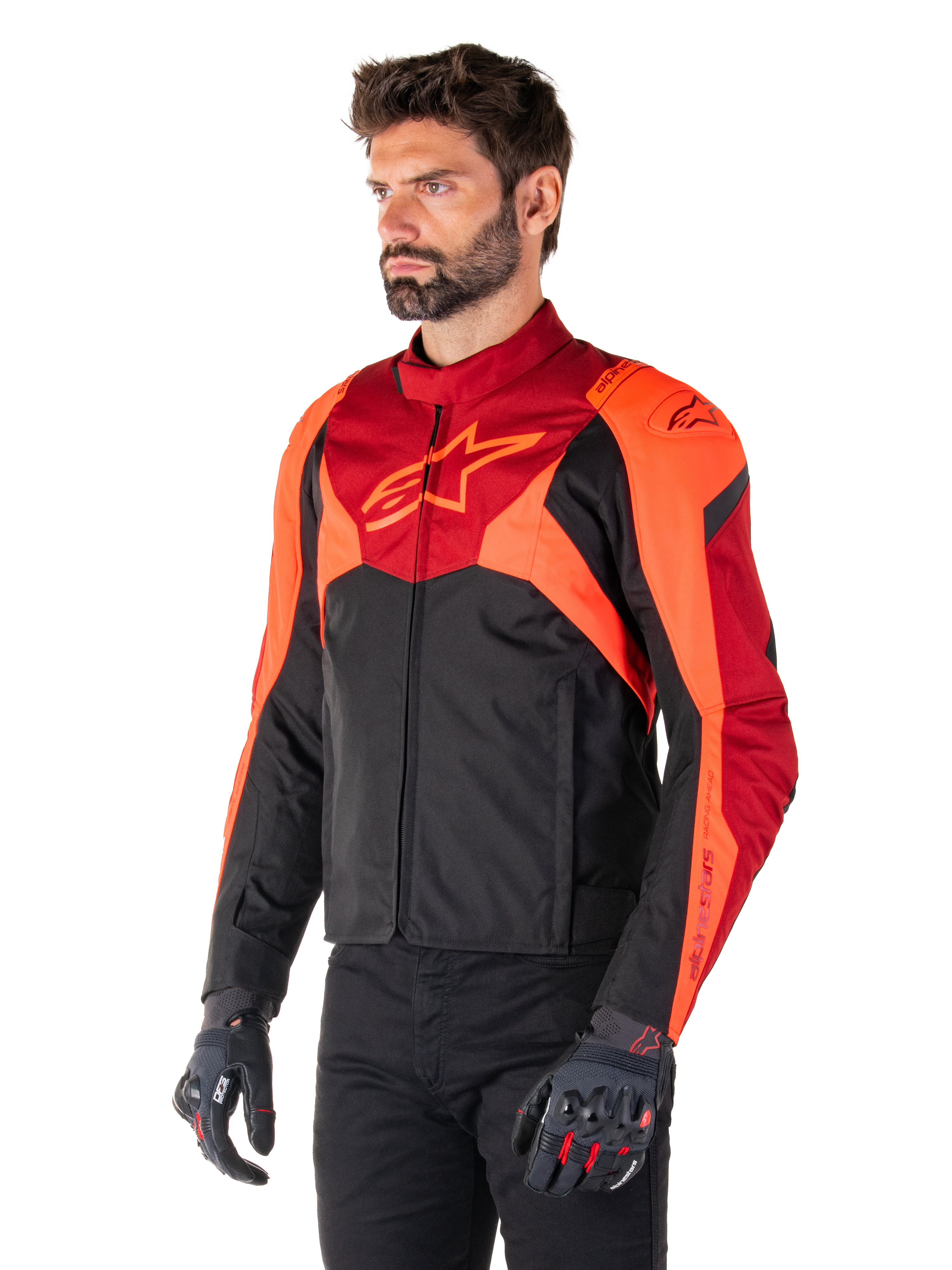 Alpinestars T-Jaws V4 Waterproof Jacket, Black Red Fluo and Dark Red, worn by a male model with black pants and motorcycle gloves, aggressive sport silhouette with Alpinestars logo on the chest, three-quarter view