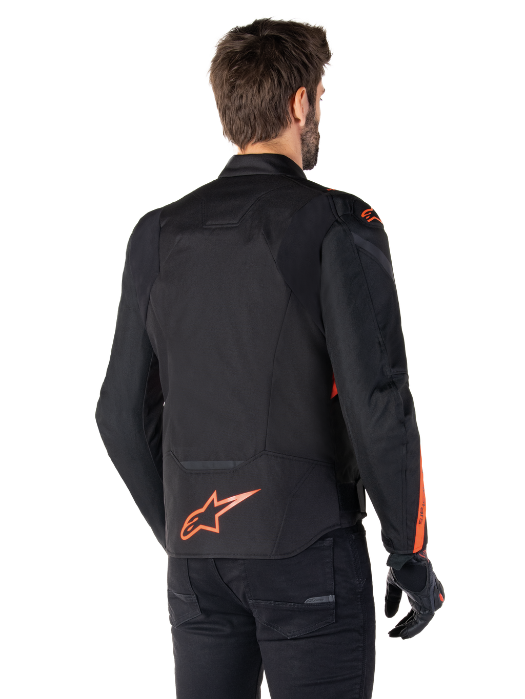 Male model wearing the Alpinestars T-Jaws V4 Waterproof Jacket from the back, Black with Red Fluo accents, featuring a red fluo logo on the lower back and accents on the shoulders and sleeves, sport motorcycle riding gear.