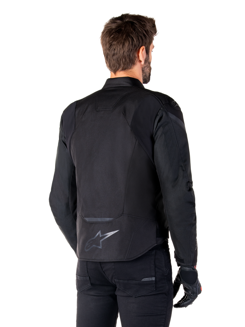 Alpinestars T-Jaws V4 Waterproof Jacket, Black, back view on model, featuring a reflective Alpinestars logo on the lower back, extended rear for coverage, sporty textile design with tonal panels, worn with black motorcycle gloves