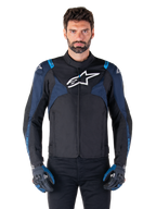 Alpinestars T-Jaws V4 Waterproof Jacket, Motorcycle Jacket, Black and Dark Blue with Blithe Blue accents, white logo on chest, blue text on shoulders, worn with matching gloves, waterproof textile riding gear