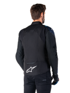 Alpinestars T-Jaws V4 Waterproof Jacket, Back View, Black with Dark Blue and Blithe Blue details, white star logo on lower back, sport silhouette, worn with black pants and riding gloves
