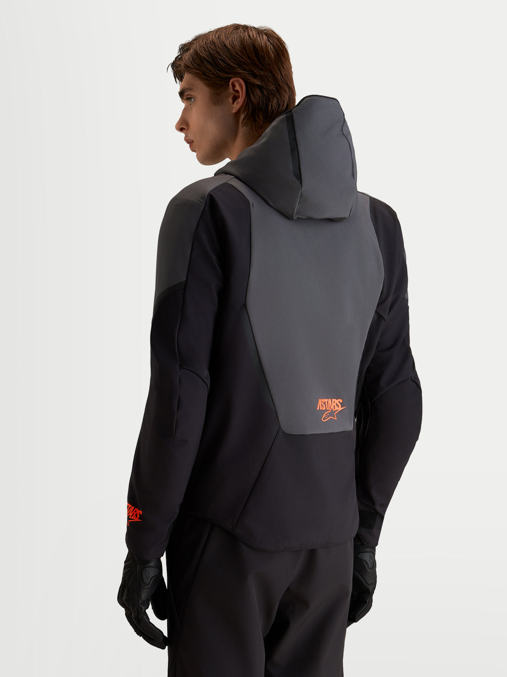 Alpinestars Aeroshell Waterproof Jacket, Men's Motorcycle Sport Softshell in Black and Dark Gray, featuring an integrated hood and back panel detail