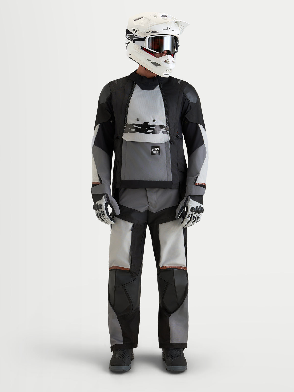 Alpinestars Harok V2 Drystar® Jacket, men's all-terrain adventure motorcycle textile jacket in dark gray, ice gray, and black, front view worn by a model wearing a matching helmet and gear, AA certified waterproof adventure riding apparel.