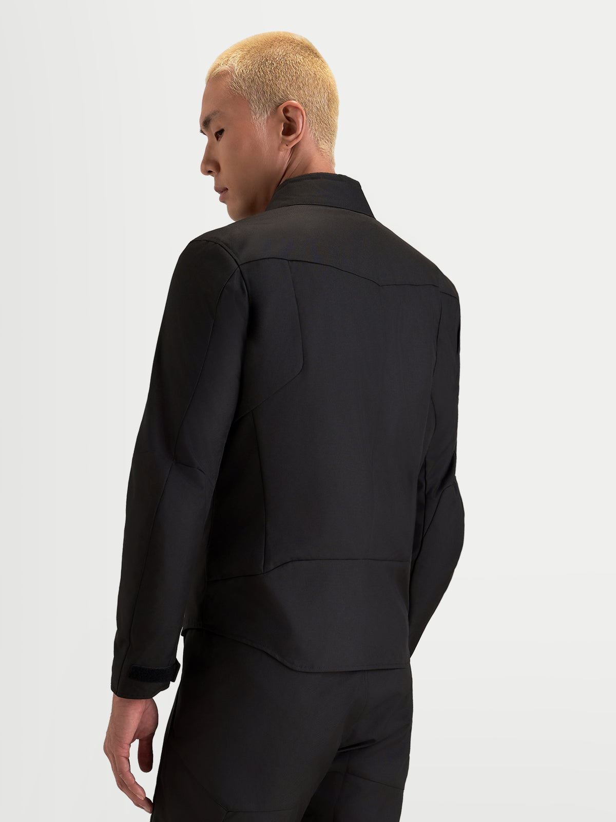 Alpinestars C-1 Waterproof Jacket, men's urban contemporary motorcycle textile jacket in black, rear three-quarter view showing 3D back pattern and soft-finish collar worn by a model.