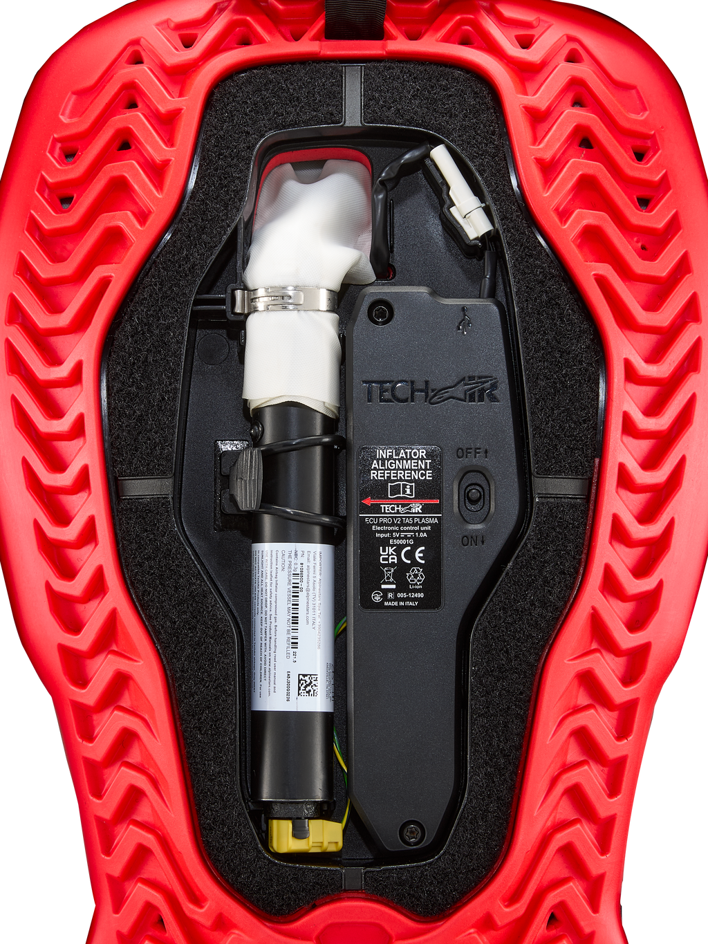 Alpinestars Tech-Air® 5 Plasma Airbag Replacement Canister, Airbag System Accessory, red and black, close-up internal view showing the white argon inflator canister with silver clamp, electronic control unit with ON/OFF switch, and wavy ribbed red outer shell