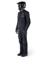 Alpinestars AMT-8 Stretch Drystar® XF Jacket, Adventure Motorcycle Jacket, Black, worn with matching pants, helmet, and gloves, featuring Alpinestars Motion Technology branding with orange accents, durable stretch construction for adventure riding