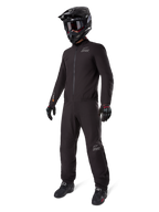 Alpinestars AMT-8 Stretch Drystar® XF Liner, black waterproof motorcycle suit, worn with black helmet, goggles, and gloves, featuring AMT and Drystar XF branding, functional adventure gear for all-weather protection.