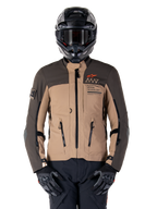 Alpinestars AMT-8 Stretch Drystar XF Jacket, Motorcycle Adventure Touring Jacket, Dark Khaki and Dark Brown, featuring orange Astars logo and black zippers, worn with black adventure helmet and gloves, full riding gear setup