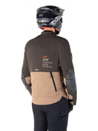 Alpinestars AMT-8 Stretch Drystar® XF Jacket, Adventure Motorcycle Jacket, Dark Brown and Dark Khaki, rear view showing AMT Alpinestars Motion Technology branding, two-tone textile design with back ventilation zippers and shingle-style exhaust, worn with black helmet and riding pants