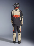 Alpinestars Halo Pro Drystar® XF Laminated Jacket, Adventure Motorcycle Jacket, Mastic Black, back view of a rider wearing matching pants and a black helmet, featuring bold orange Alpinestars branding and modular ventilation panels for versatile adventure riding.
