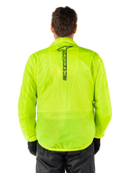 Alpinestars Hurricane Rain V2 Jacket, Motorcycle Rain Jacket, Yellow Fluo, rear view showing vertical black Alpinestars logo on center back, lightweight waterproof fabric, worn with black riding pants and gloves