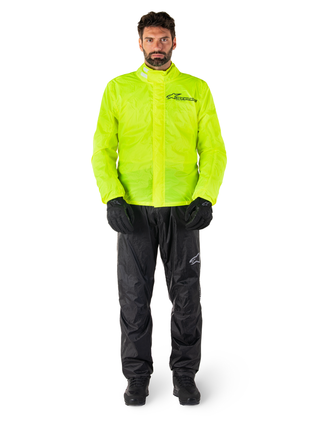 Alpinestars Hurricane Rain V2 Jacket and Pants, Neon Yellow and Black, waterproof motorcycle rain suit worn with black gloves and boots, featuring the Alpinestars logo on the chest and leg