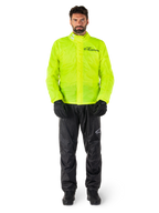Alpinestars Hurricane Rain V2 Jacket and Pants, Neon Yellow and Black, waterproof motorcycle rain suit worn with black gloves and boots, featuring the Alpinestars logo on the chest and leg
