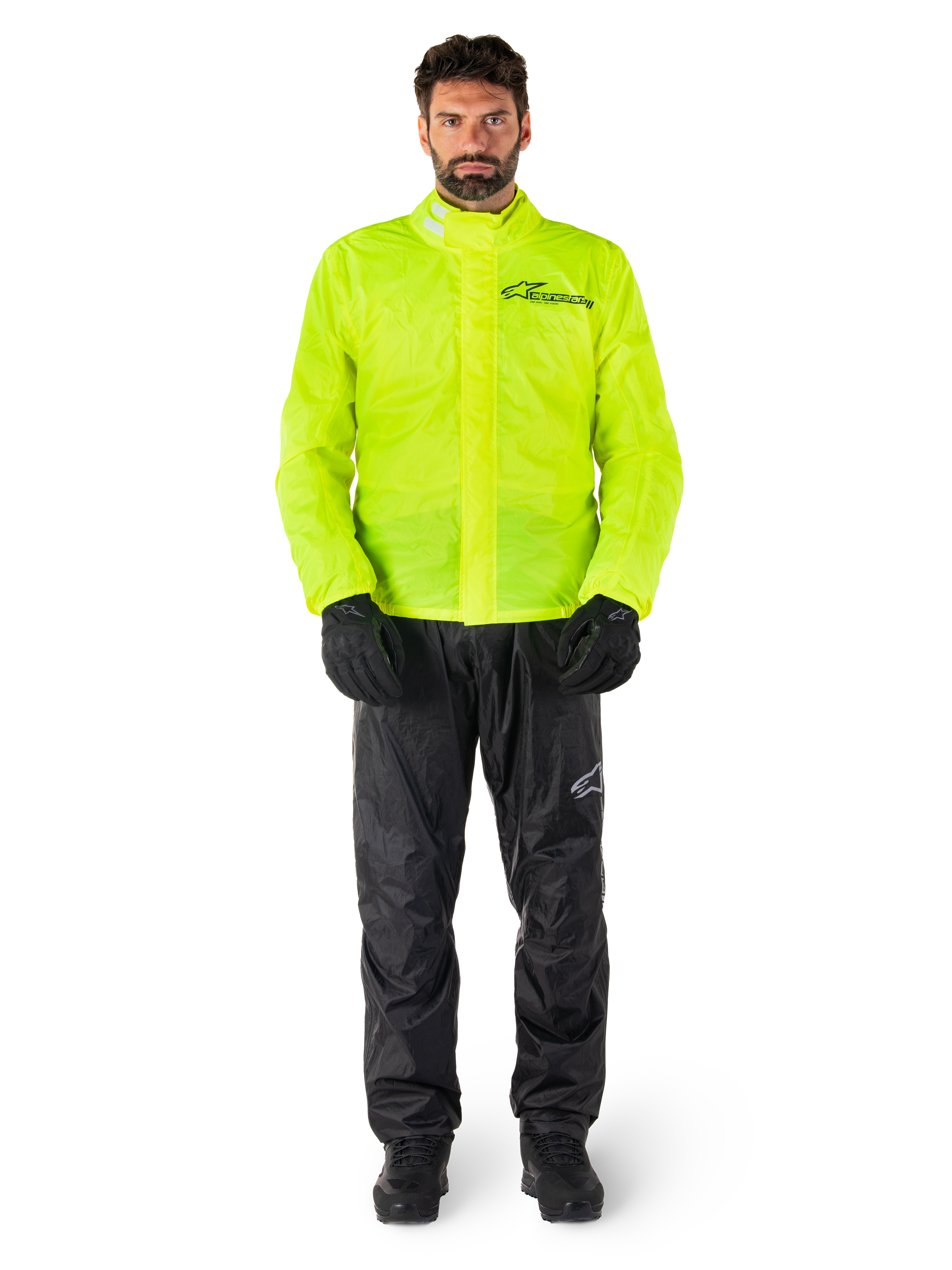Alpinestars Hurricane Rain V2 Jacket and Pants, Neon Yellow and Black, waterproof motorcycle rain suit worn with black gloves and boots, featuring the Alpinestars logo on the chest and leg