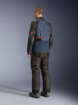 Alpinestars Andes V4 Drystar® Jacket, Night Navy and Mood Indigo with Black panels and red accents, back three-quarter view, worn with matching black adventure riding pants and boots, technical textile construction with Alpinestars logo on the upper back, elongated rear hem for coverage.