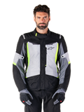 Alpinestars ST-1 Waterproof Jacket, adventure touring motorcycle jacket, Ice Gray Black and Yellow Fluo, worn by a man with matching gloves and black pants, featuring neon yellow accents on the chest and collar, Alpinestars logo on the chest
