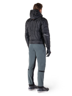 Alpinestars Mohobbs Waterproof Jacket, Black, Rear view of quilted padded bomber jacket with embossed vertical wordmark on the back, styled with grey riding pants and black gloves, urban streetwear-inspired motorcycle gear