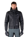 Alpinestars Mohobbs Waterproof Jacket, Black Padded Bomber Motorcycle Jacket, quilted poly fabric with front zipper and zippered pockets, small white logo on chest, worn by a model with grey pants and gloves, urban streetwear design for city riding.