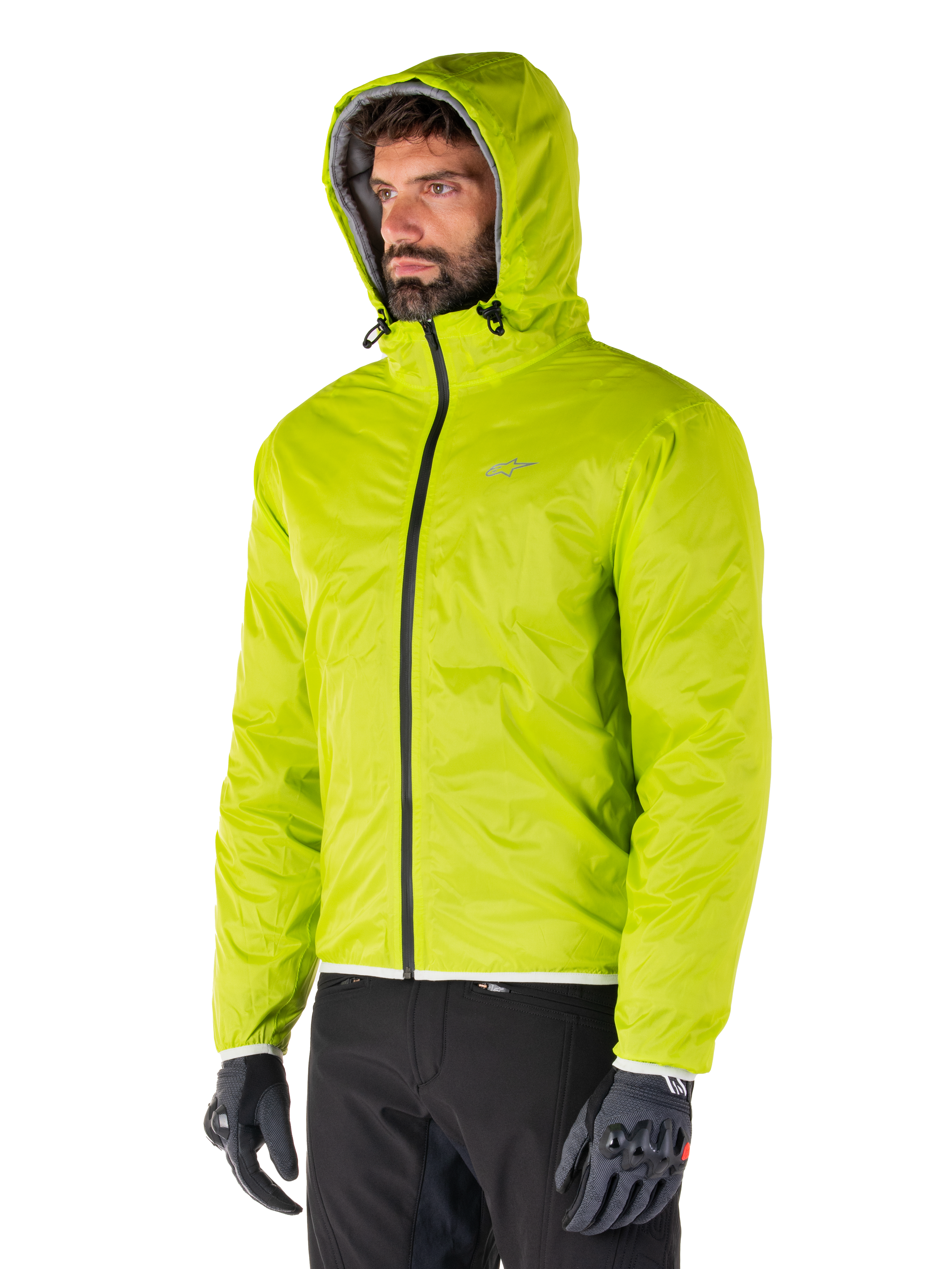 Alpinestars Mohobbs Waterproof Jacket, Lime Punch packable rain liner, bright neon green hooded jacket worn with black pants and gray gloves, urban streetwear-inspired motorcycle apparel