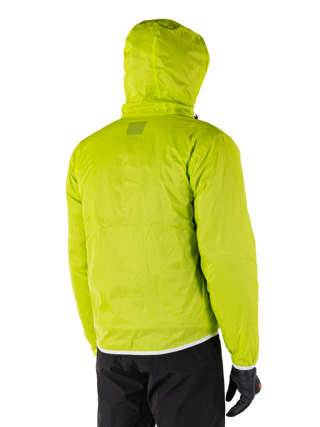 Alpinestars Mohobbs Waterproof Jacket, packable rain liner in Lime Punch, rear view of the hooded neon green waterproof layer, worn with black motorcycle pants and gloves
