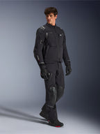 Alpinestars Andes Pro Drystar® XF Jacket, Black and Dark Gray motorcycle jacket, worn by male model with matching adventure pants, gloves, and boots, full-body studio shot, technical adventure touring gear with reflective details and branding