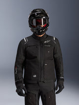 Alpinestars Cusco Drystar® Jacket, Black motorcycle adventure touring jacket, worn with a black full-face adventure helmet and dark goggles, featuring multiple utility pockets, Alpinestars branding on the chest, and Drystar® logo on the sleeve, part of a complete road adventure outfit.