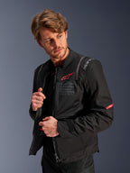 Alpinestars ST-2 Air Jacket, Black Men's Motorcycle Touring Jacket with mesh panels and red logo, worn by a model.