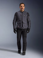 Maxdura Drystar®XF Laminated Armored Shell, Motorcycle Jacket, Deep Gray Black, worn by a model with black pants and gloves, featuring large cargo pockets, red zipper accents, and All Terra branding, technical adventure riding gear