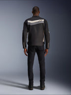 Alpinestars T-Dyno WR Jacket, textile motorcycle jacket, Black Dark Gray and Ecru, back view showing horizontal stripe across shoulders with small star logo, worn by model with black pants and boots, vintage-inspired road riding gear