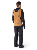 Alpinestars Hyde XT Stretch Drystar®XF Jacket and Hyde XT Drystar® Pants, rear view of a rider wearing tan and black adventure touring gear, jacket featuring vertical back zippers and Alpinestars branding, black pants with red star logo on the calf, paired with black gloves and boots.
