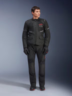 Male model wearing Alpinestars Andes Air Drystar® Jacket in Black, adventure touring motorcycle gear with matching pants and gloves, featuring red logo on the chest, mesh ventilation, and functional pockets.