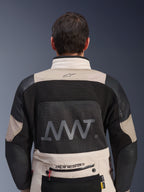 Rear view of Alpinestars AMT-10LAB Drystar® XF Jacket in White Sand and Black, featuring a large AMT logo on the mesh back panel, Alpinestars branding on the lower back, and technical textile construction for adventure motorcycling