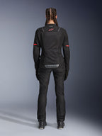 Alpinestars Stella ST-2 Air Jacket, Women's Motorcycle Jacket, Black, rear view featuring red logo on upper back and grey branding on lower back, worn with matching black riding pants and boots, modern touring design with mesh panels and reflective details