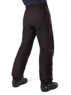 Alpinestars Amt-8 Stretch Drystar® XF Pant Liner, Black, rear view showing the waterproof liner worn over black motorcycle boots, featuring Drystar XF branding on the lower leg, elasticated ankle cuffs, and lightweight stretch material for adventure touring.