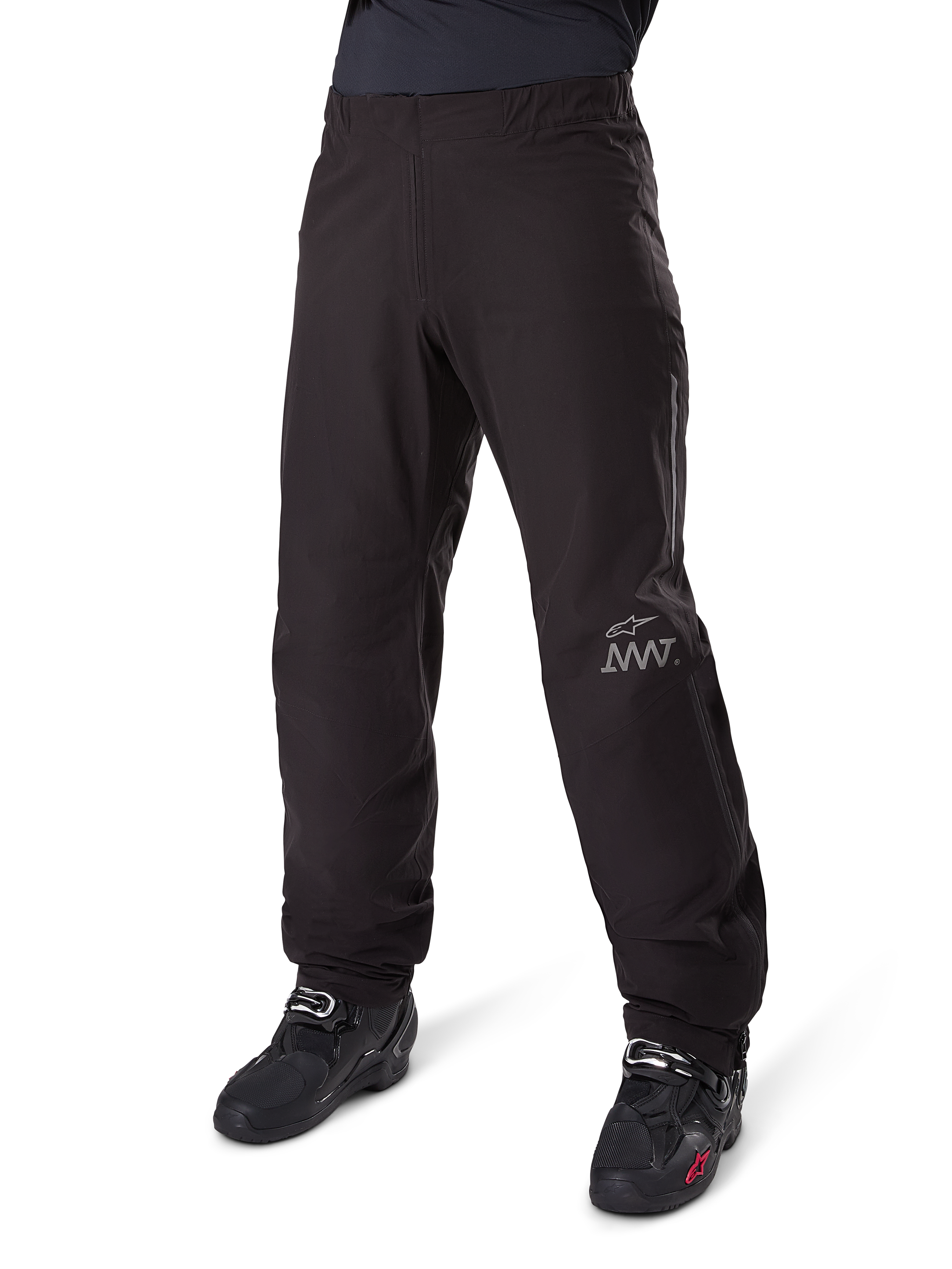 Alpinestars Amt 8 Stretch Drystar® XF Pant Liner, Waterproof Motorcycle Pants, Black, featuring a grey AMT logo on the lower left leg, worn with black motorcycle boots, functional design for all-weather adventure riding